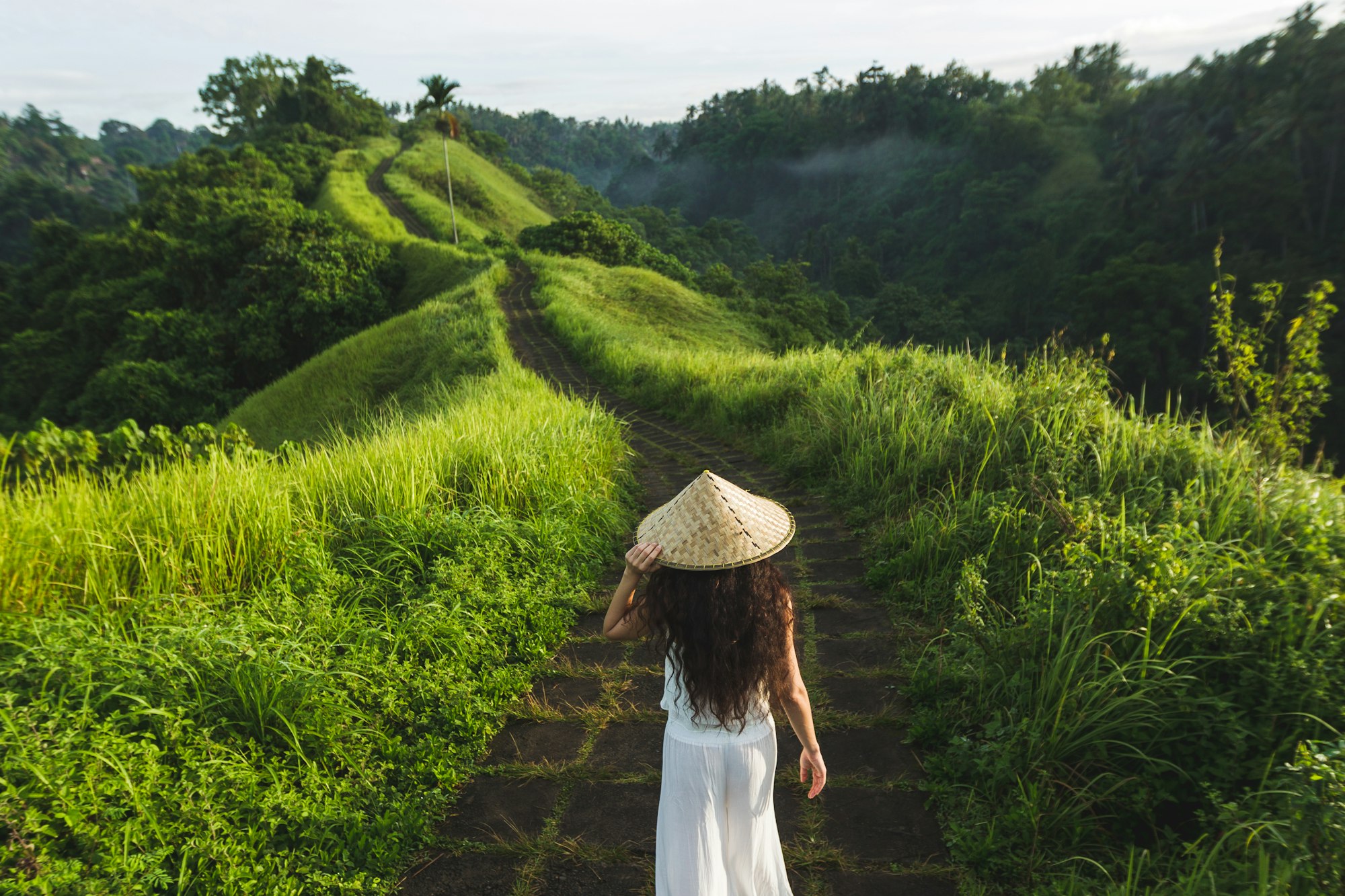 young-beautiful-woman-walking-on-campuhan-ridge-way-of-artists-in-bali-ubud-1.jpg